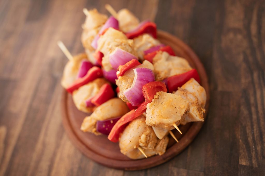 Signature Marinated Chicken Tip Kabobs. Made with fresh bell pepper and red onion.