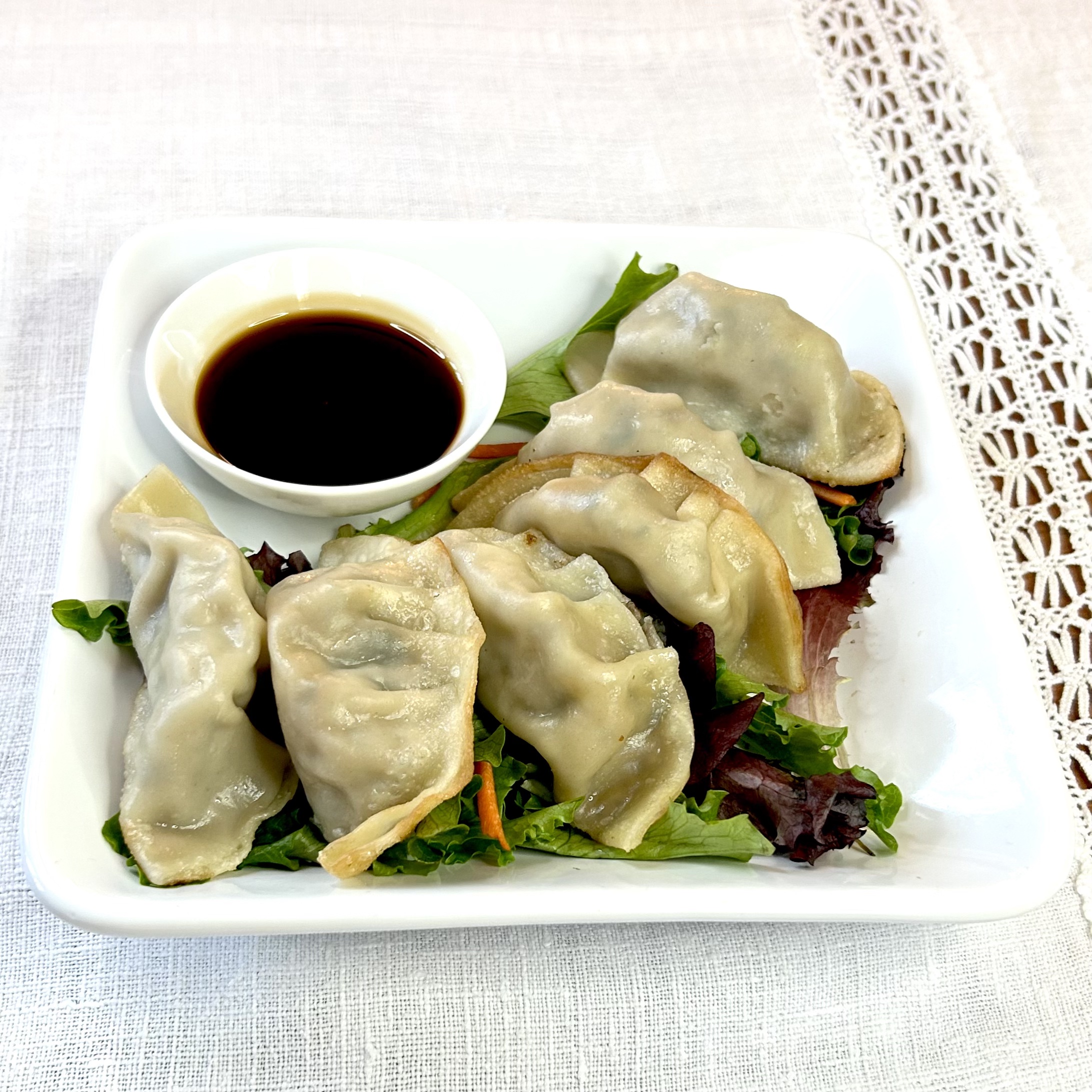 traditional asian style potstickers made by APM professional chefs. Available in lemon grass chicken, pork, shrimp, and kimchi varieties.