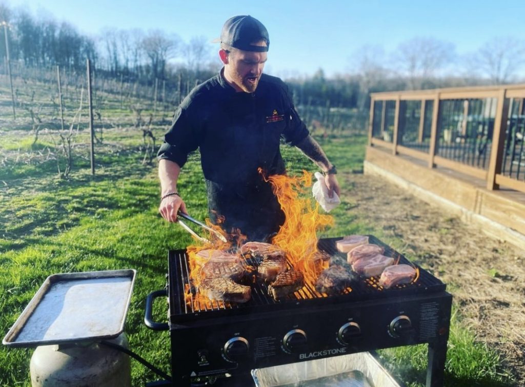 Chef Miller grilling on-site at Lost Acres Vineyard in Granby.
